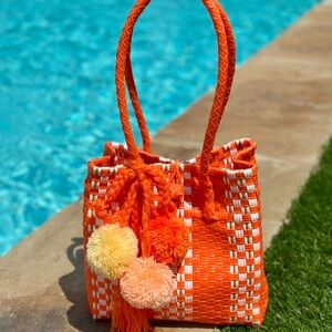 Vibrant Orange Woven Shoulder Bag with Pom Poms